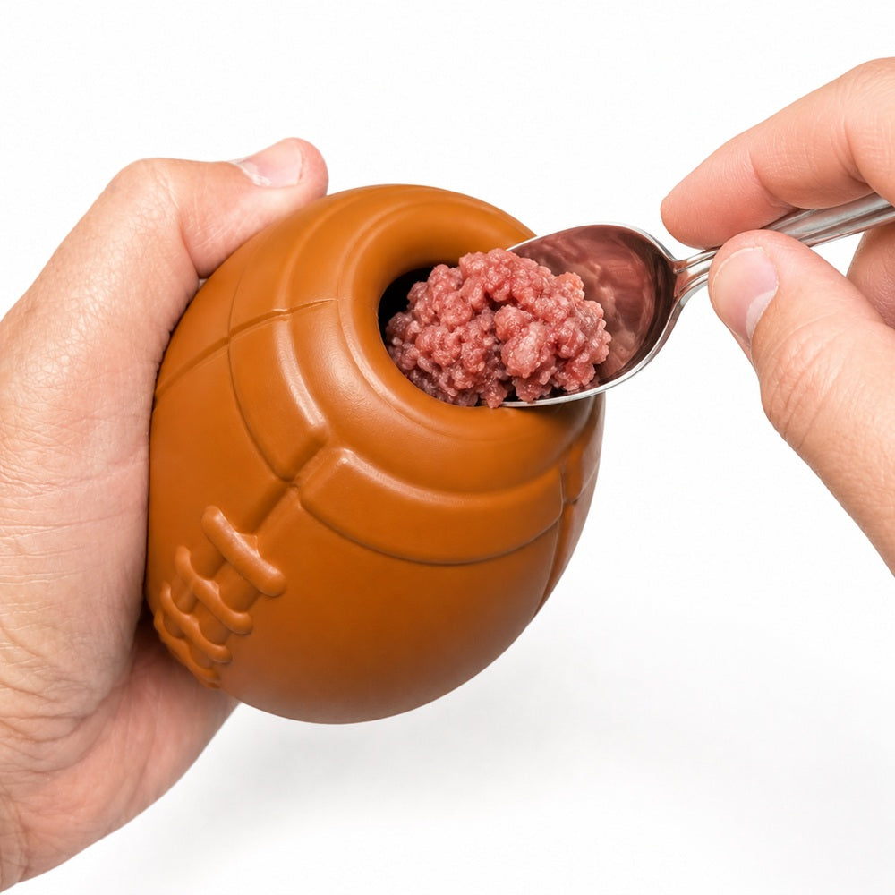 Brown football treat-dispensing dog toy