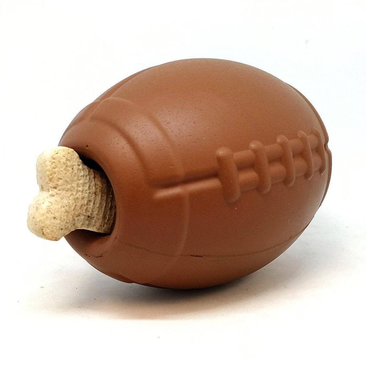 Football treat-dispensing dog toy in use